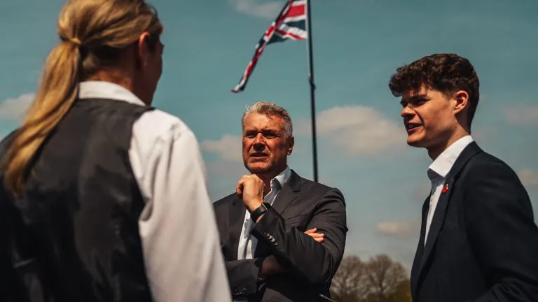 Bradley Reames and Max Reames speaking to a member of staff.